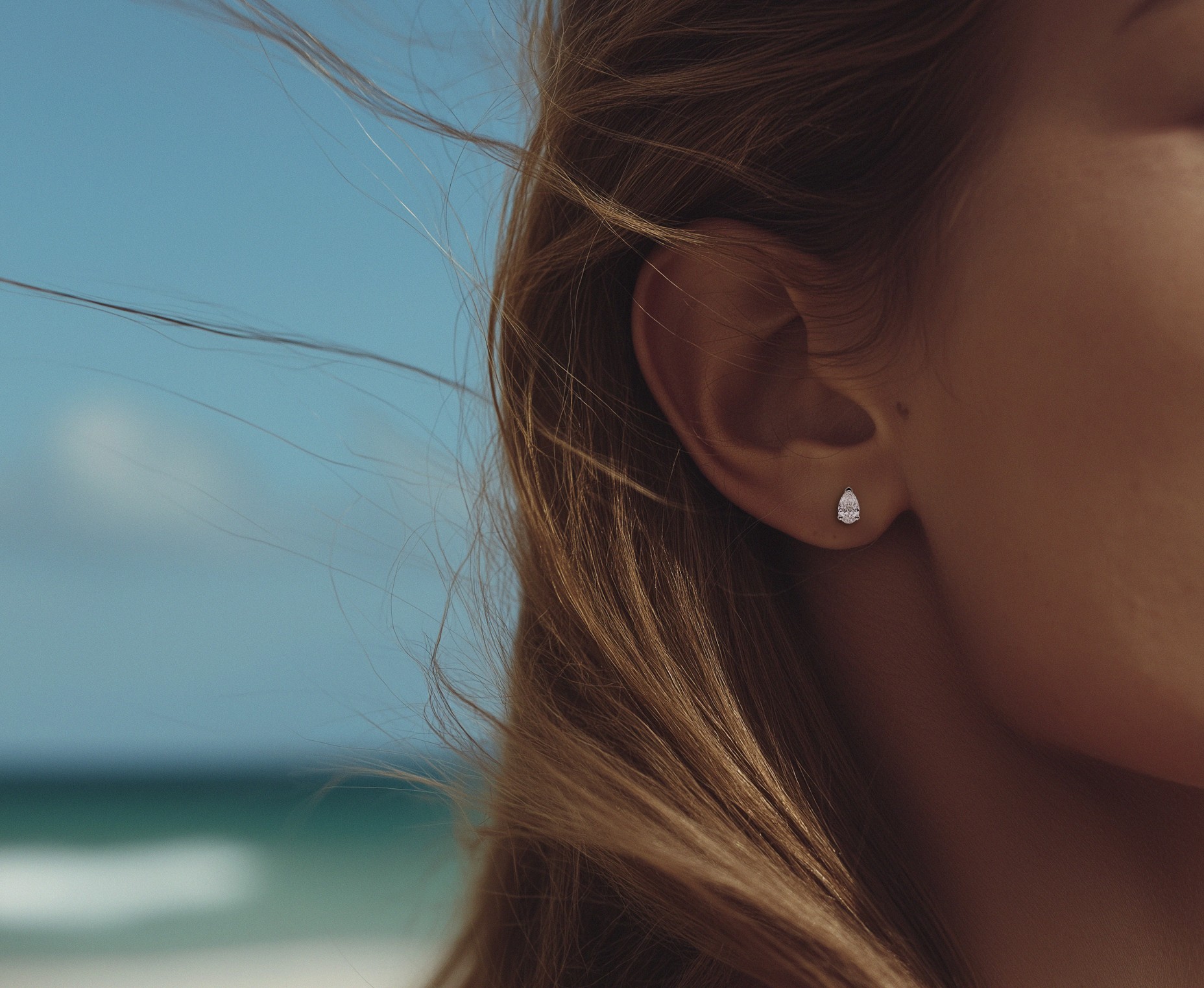 Pear lab diamond earring in females ear